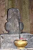 Candi Cetho - Penis sculpture with two balls in a pavilion of one of the upper terraces. 